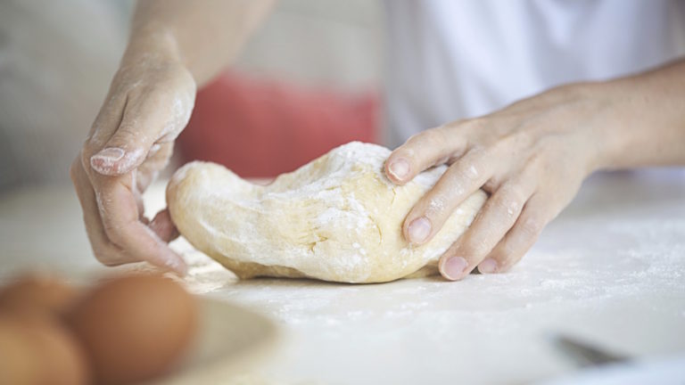 Image of hands kneading dough, for dough wines red blends blog post