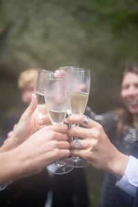 cheers three people touching sparkling wine glasses