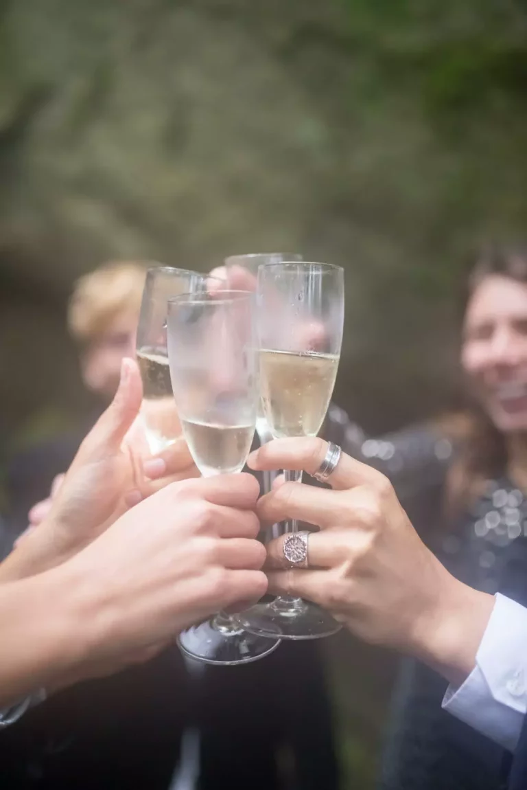 cheers three people touching sparkling wine glasses