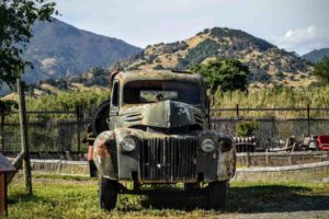 Green truck in front of a Napa Valley vineyard